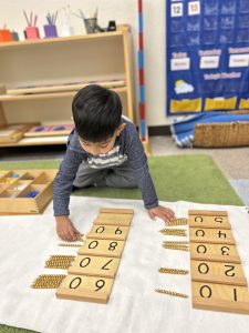 Vpk age student using beads to count by 10's, from 10 to 100