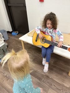 Young girl playing guitar at the Best VPk and Primary School in Fruit Cove, FL 32259